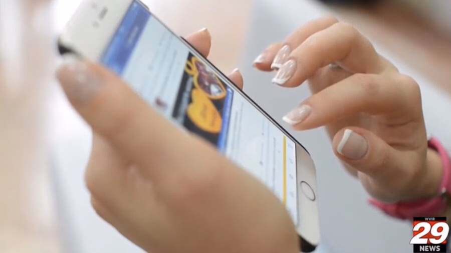 A young person scrolling through a social media feed on a smartphone.