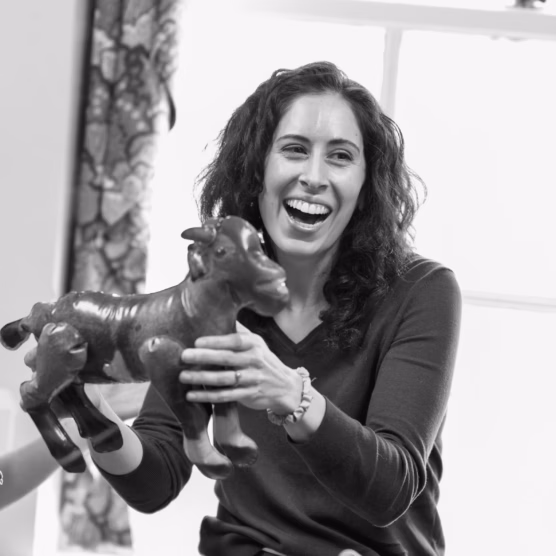photo of Adrienne Wood laughing at an inflatable goat